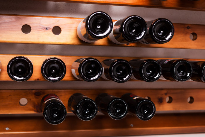 Butelki wina jako inwestycja - na półkach w piwniczce